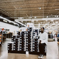 a man sitting on a pile of boxes in a store